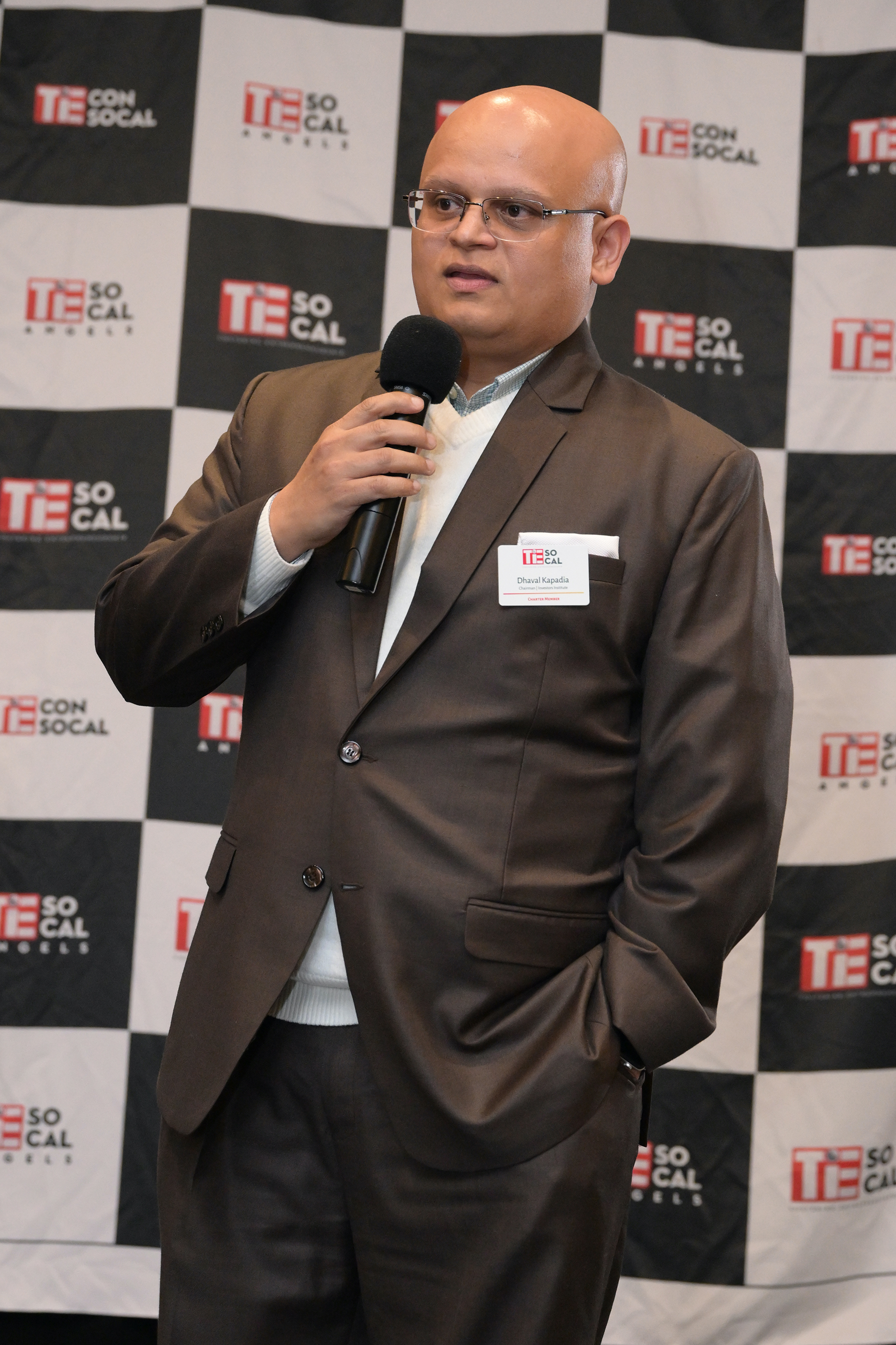 Dhaval Kapadia speaking on stage